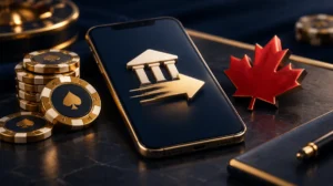 A smartphone with a bank transfer arrow over it, gold chips and a red maple leaf on a dark desk